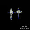 A pair of silver crucifix pendants featuring a figure of Christ with blue enamel finish.
