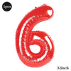 A shiny red foil balloon shaped like the number 6, indicating a 32-inch size.