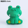 A small, green frog-shaped decoration with yellow accents for birthday decorations.