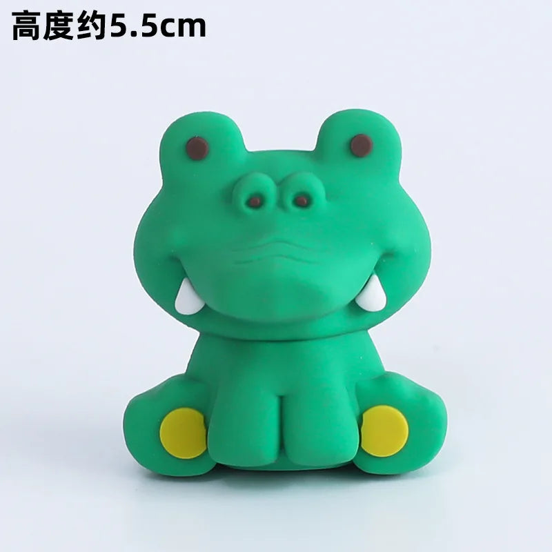 A small, green frog-shaped decoration with yellow accents for birthday decorations.