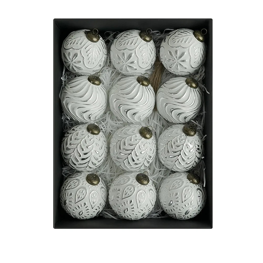 A set of twelve white, decorative, leaf-patterned shatterproof Christmas tree ball ornaments packaged in a box.