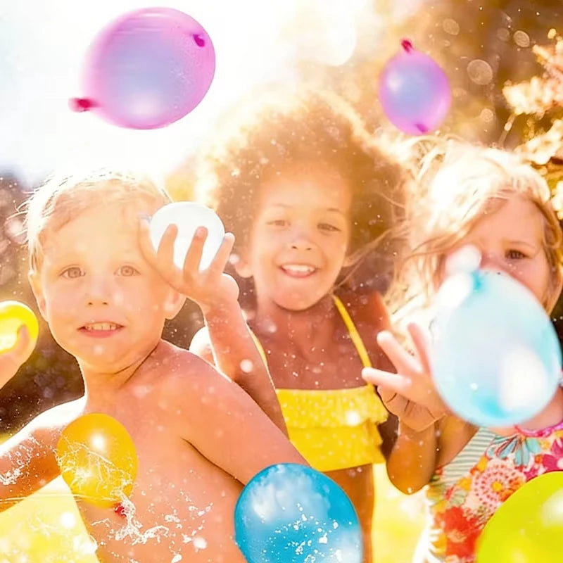 Three happy children joyfully play with colorful water balloons outdoors.