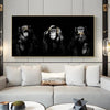 A canvas wall art print featuring three black and white photographs of monkeys against a dark background.