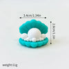 A set of three sea creature cake toppers, including a whale, octopus, and turtle, made of light blue frosting.