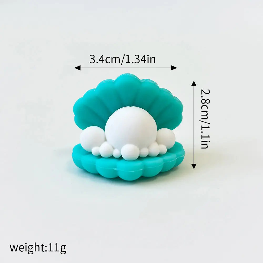 A set of three sea creature cake toppers, including a whale, octopus, and turtle, made of light blue frosting.