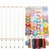 Wall-mounted headband holder with various colored fabric headbands for girls