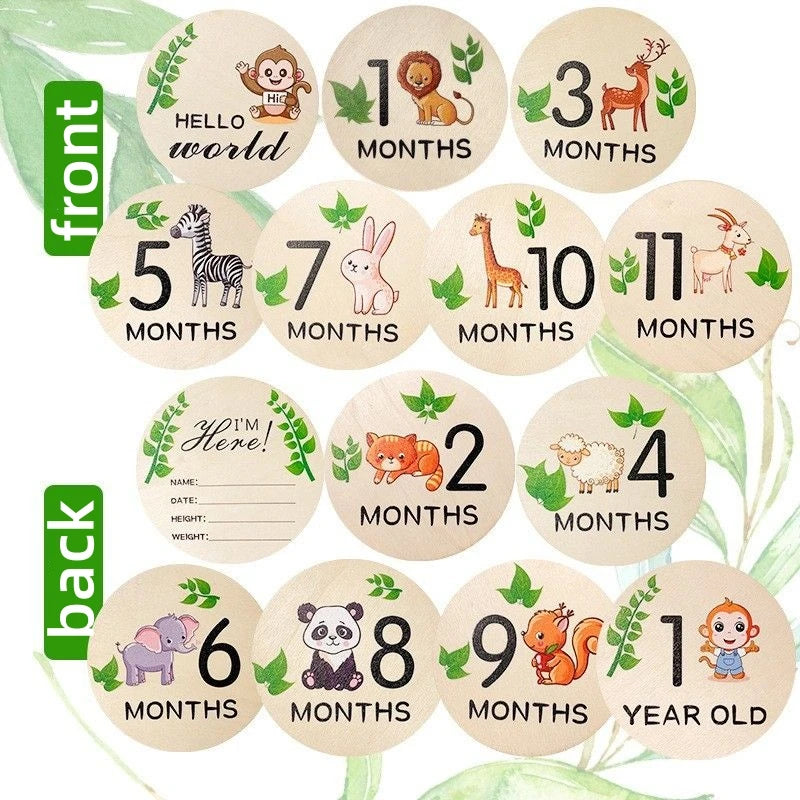 A collection of circular wooden signs showing various animal figures and age milestones from newborn to one year old.