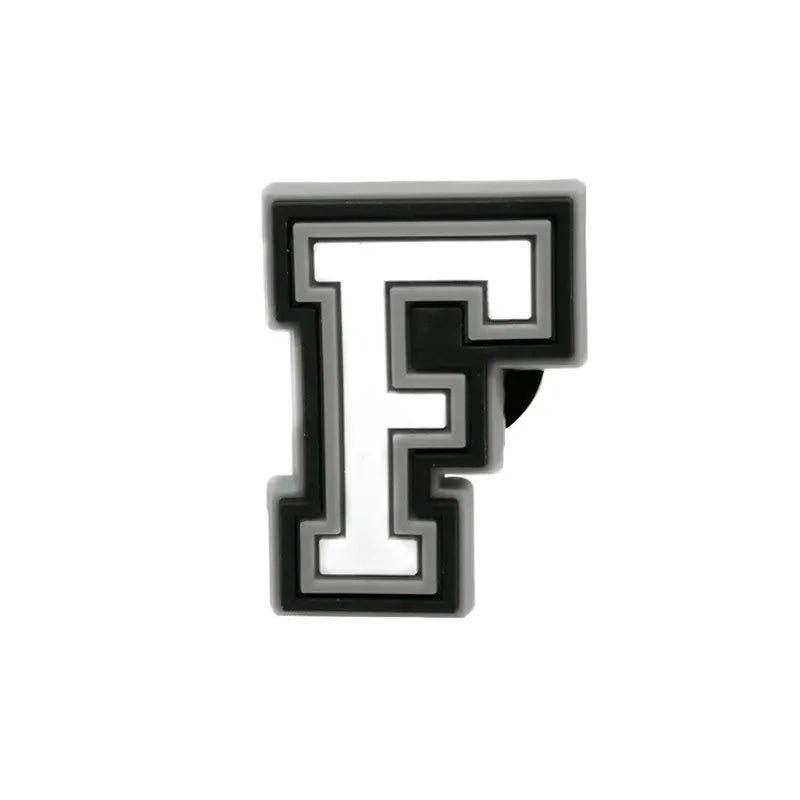 Charm en forme de lettre F, noir et blanc.