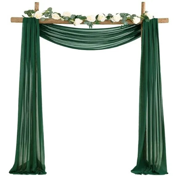 Emerald green chiffon drapes forming an elegant arch for weddings and events