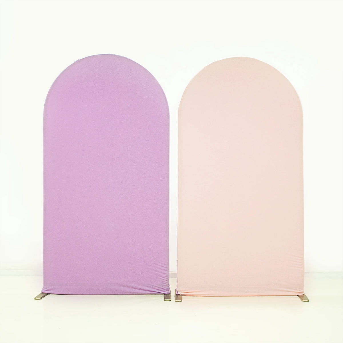 A pair of seamless stretchable arch backdrop covers in lavender and blush pink.