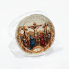 A silver commemorative coin depicting the crucifixion and resurrection scenes with biblical figures.