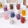 A collection of natural fox crystal sculptures in various colors including purple, orange, yellow, and pink, displayed on a w