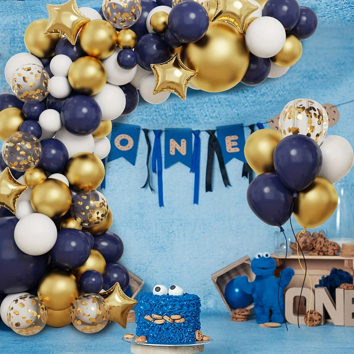 A balloon garland arch kit featuring navy blue and gold balloons decorating a blue background.