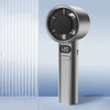 A silver handheld cooling fan with a circular grille and digital display showing 120 degrees.