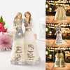 A pair of angel friendship statues in white and silver, featuring engraved text on the base.