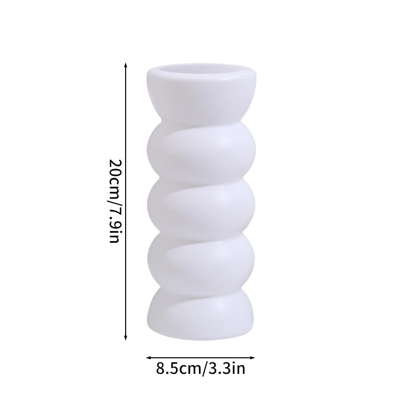 Modern white plastic decorative vase with stacked, rounded segments.