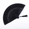 A black traditional Chinese folding fan with a pleated design.
