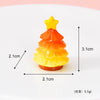 A small, layered orange and yellow resin Christmas tree charm with a gold star topper.