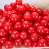 A large quantity of bright red, glossy spherical balls for play areas and ball pits.