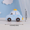 Light blue baby block car topper with a yellow roof and a key detail, shown on a white surface.