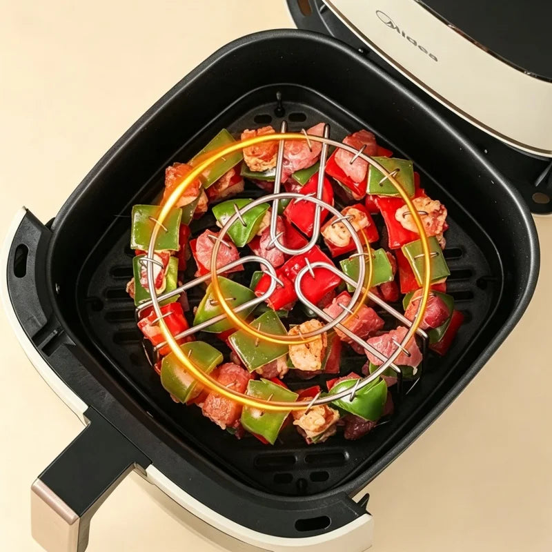 Stainless steel vertical skewer rack with meat and vegetables cooking in an air fryer basket