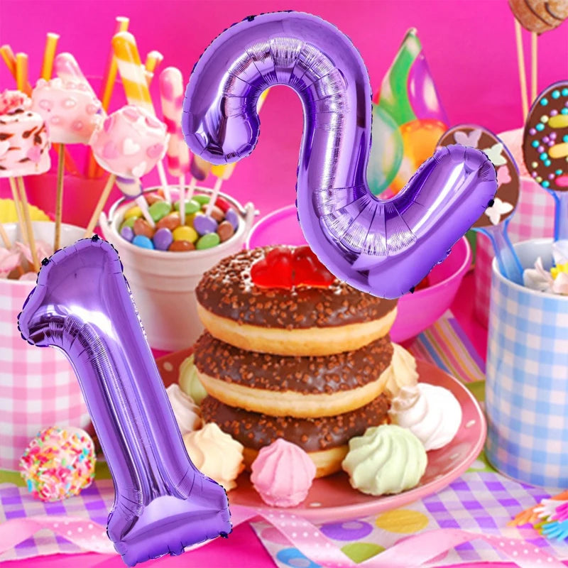 A purple foil number balloon shaped like the number 9 floats above a stack of pancakes and colorful treats.
