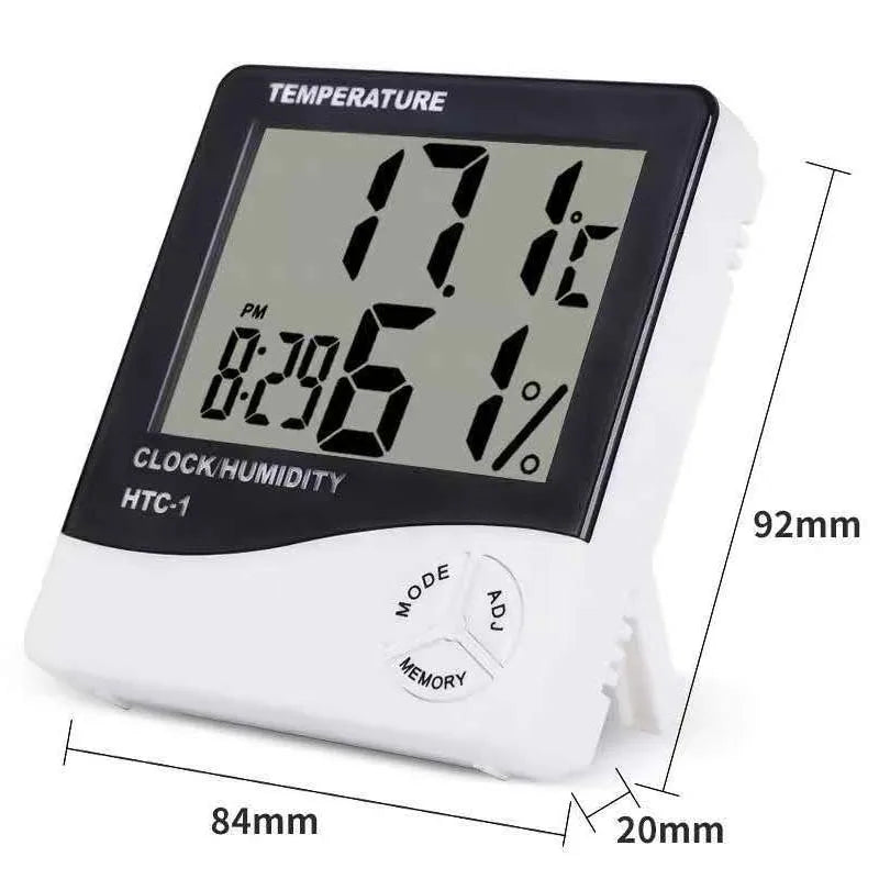 A white LED digital thermometer and hygrometer with an alarm clock display showing 17.6 degrees.