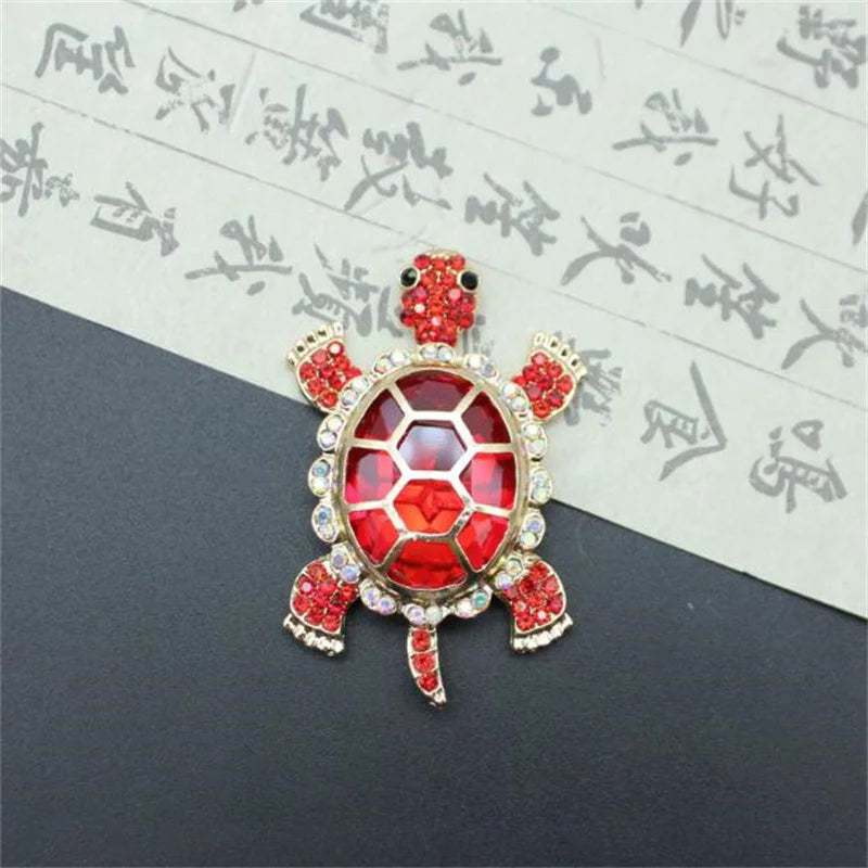 Vintage marine life brooch pin set featuring a red, translucent, dome-shaped design with gold accents.