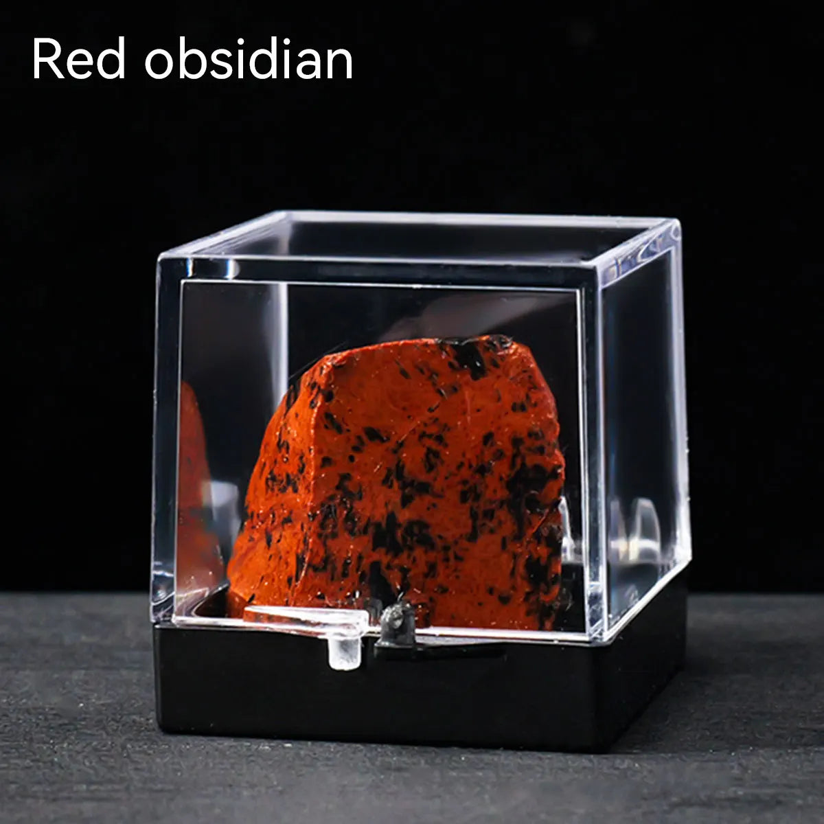A reddish-brown obsidian rough stone specimen displayed inside a clear glass box.