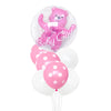 A pink foil balloon shaped like a bear with glitter and text, surrounded by white polka dot balloons.