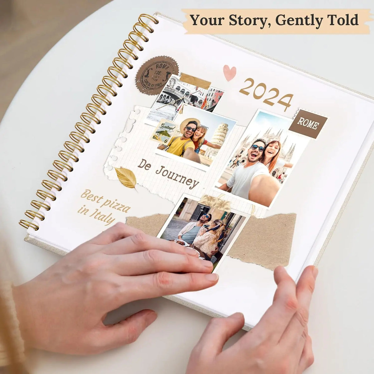 Hands are placing photos into a linen cover scrapbook album titled Your Story, Gently Told for 2024.