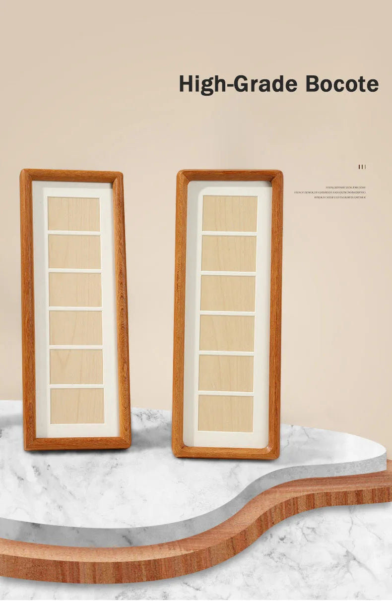 A high-grade bocote photo frame display stand featuring a light wood frame and white interior, resting on a marble surface.