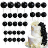 A set of black foam cake toppers on sticks arranged in various patterns.