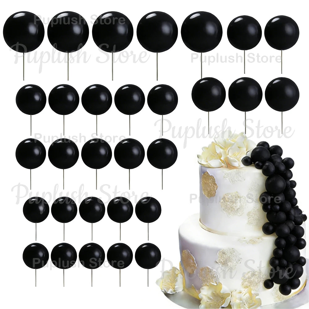A set of black foam cake toppers on sticks arranged in various patterns.