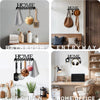A collection of metal kitchen tools and utensils hanging on a wall display in a bathroom, entryway, and kitchen.