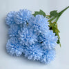 A bouquet of artificial light blue hydrangea and green camellia flowers.
