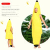 A child wearing a yellow banana costume with a hood and face paint, standing in front of green foliage.