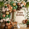 A balloon garland featuring safari and jungle prints in shades of green, gold, brown, and beige.