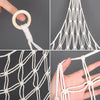 Close-up view of a white multi-use storage hammock for toys and plushies showing various ways to tie and use the netting