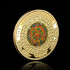 A gold-plated commemorative coin featuring a Mayan calendar design and text.