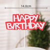Red cake topper with white lettering that reads HAPPY BIRTHDAY