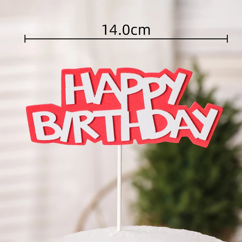 Red cake topper with white lettering that reads HAPPY BIRTHDAY
