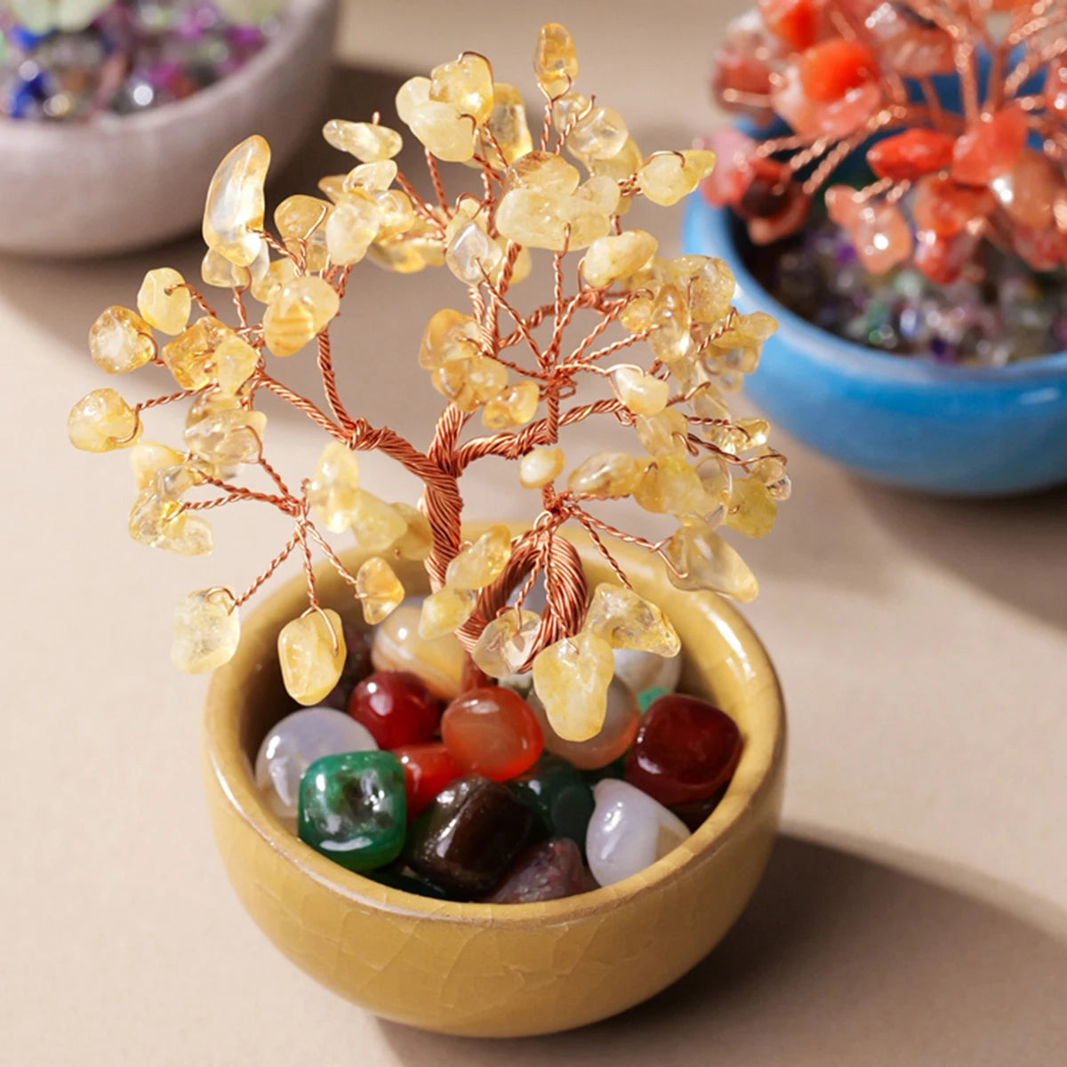 Handcrafted crystal tree with a natural stone base and copper wire branches