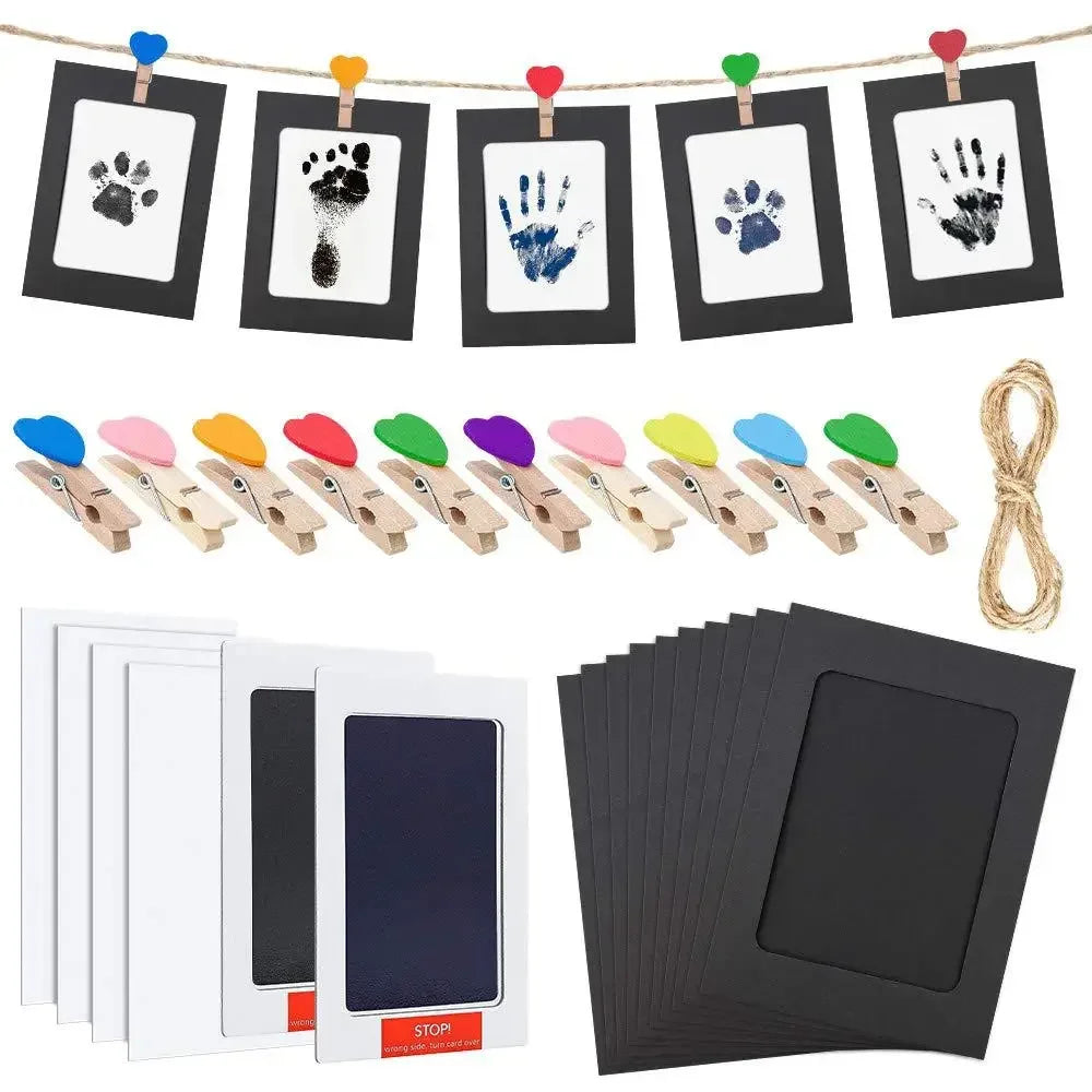A kit containing handprint and footprint ink pads, including various colored pads and black silicone stamps.