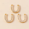 Two gold horse charm pendants for handmade jewelry displayed on a light background.