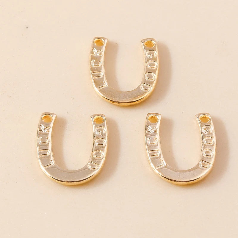 Two gold horse charm pendants for handmade jewelry displayed on a light background.