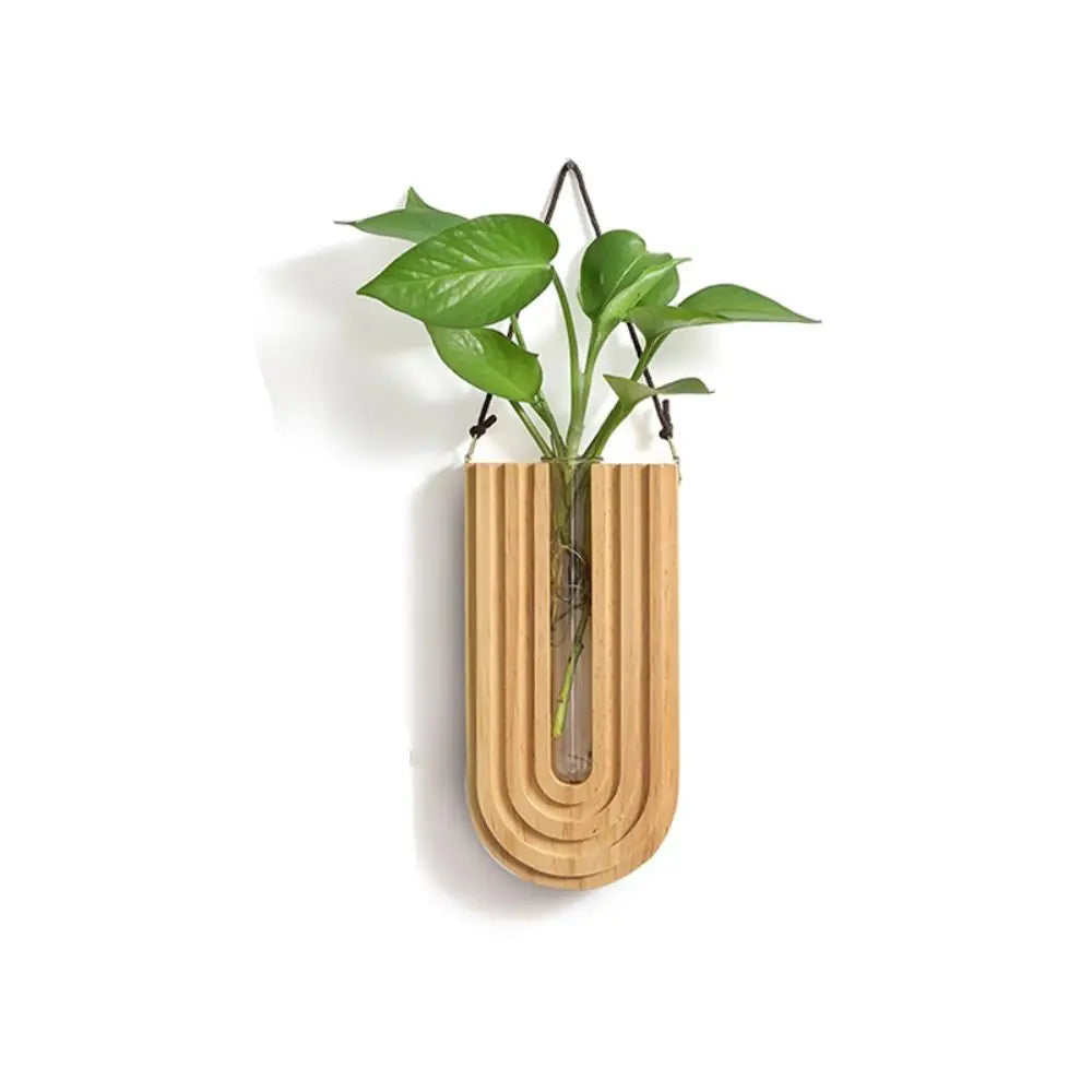 Handcrafted wooden wall-mounted hydroponic plant vase with green leaves