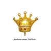 A golden foil crown balloon used for birthday and party decoration.