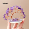 A natural amethyst crystal tree with purple clusters on a white agate base.