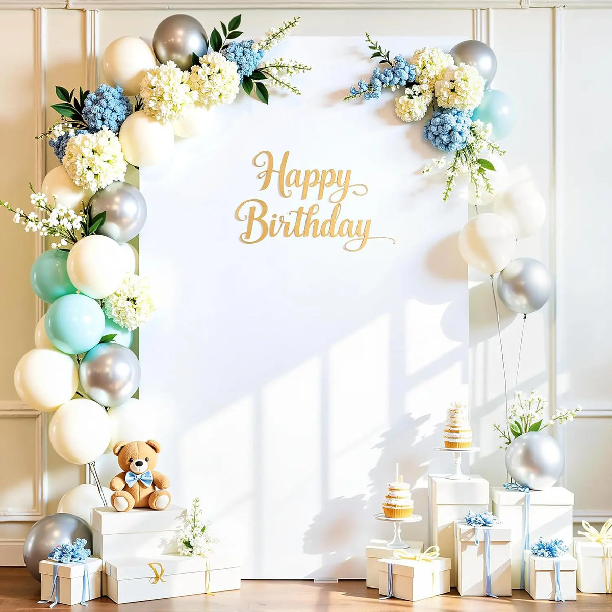 Fondo arqueado blanco decorado con globos azules y blancos, flores y un mensaje de cumpleaños dorado.